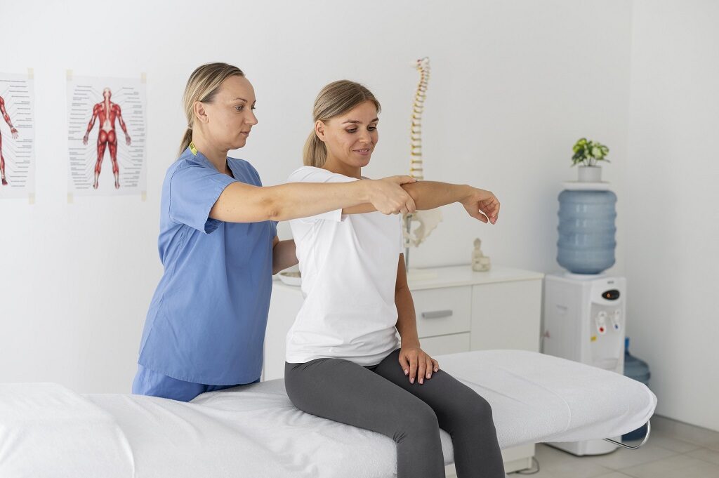 Physiotherapist Helping Female Patient